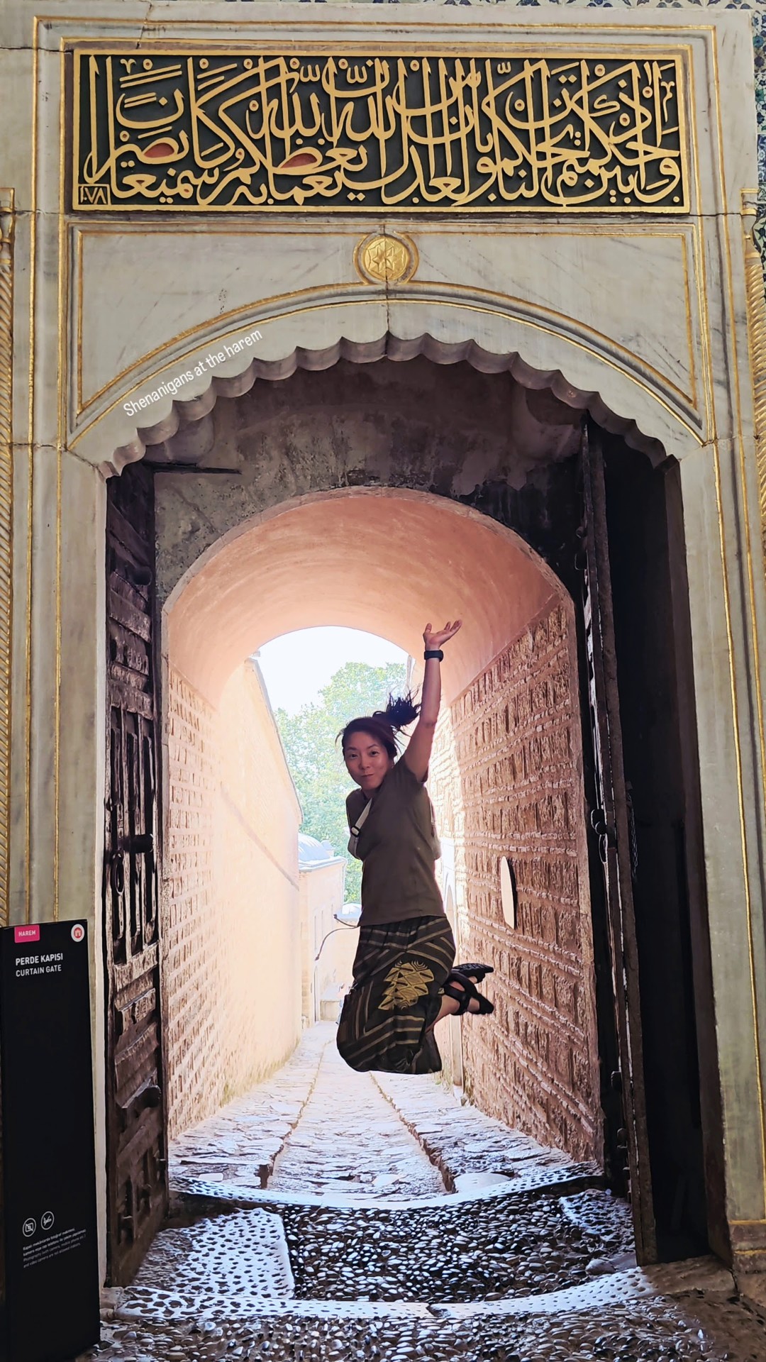 Haena mid-jump under an ornate stone archway